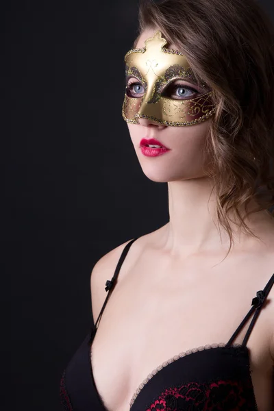 Close up portrait of beautiful woman in lingerie and mask over g — Stock Photo, Image