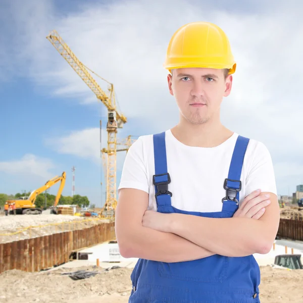 Handsome man in builder uniform at construction site — Stock Photo, Image