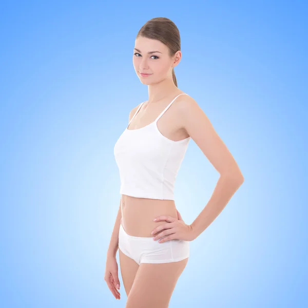 Young woman in cotton underwear over blue — Stock Photo, Image