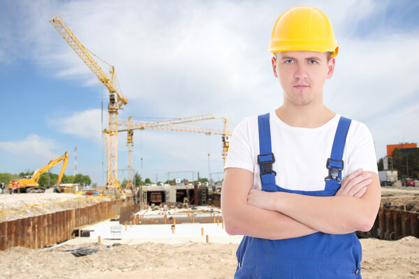 portrait of young handsome man in  builder uniform