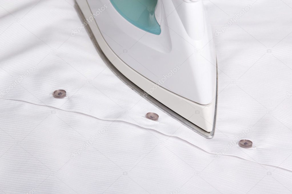 close up of iron ironing cotton shirt