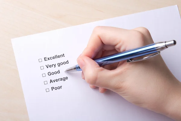 Close up of female hand with customer survey — Stock Photo, Image