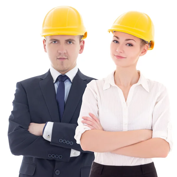 Hombre joven y mujer en cascos de constructor aislado en blanco — Foto de Stock