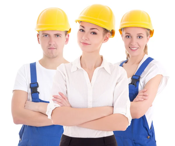 Team work concept - two young women and man in blue builder 's u — Stock Photo, Image