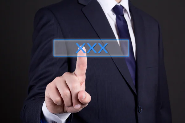 Unternehmer, die einen imaginären Knopf mit Xxx text — Stockfoto