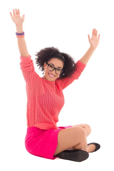 Happy african american teenage girl in pink sitting isolated on — Stock Photo, Image