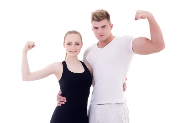 Young muscular man and slim woman in sportswear showing muscles — Stock Photo, Image