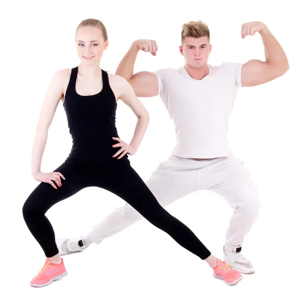 Спортивный мужчина и женщина, делать упражнения на растяжку изолированные на ничуть — стоковое фото