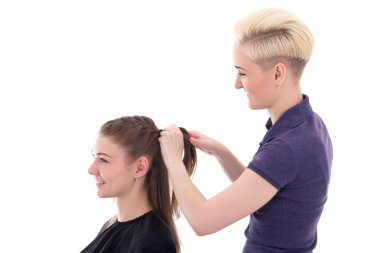 hairdresser doing haircut to young woman isolated on white