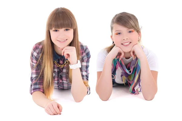 Two happy teenage girls lying isolated on white — Stock Photo, Image