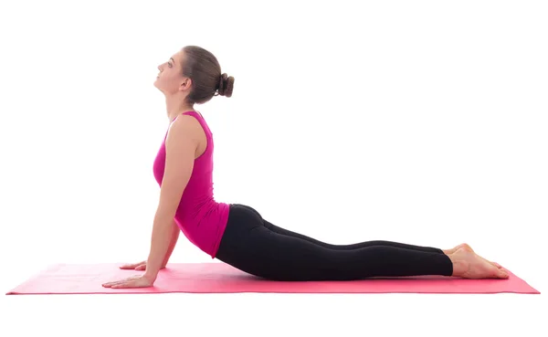 Joven mujer delgada haciendo ejercicio que estira en estera de yoga aislada —  Fotos de Stock