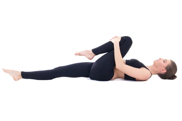 Schöne sportliche Frau liegend und tun stretching Übung isola Stockfoto