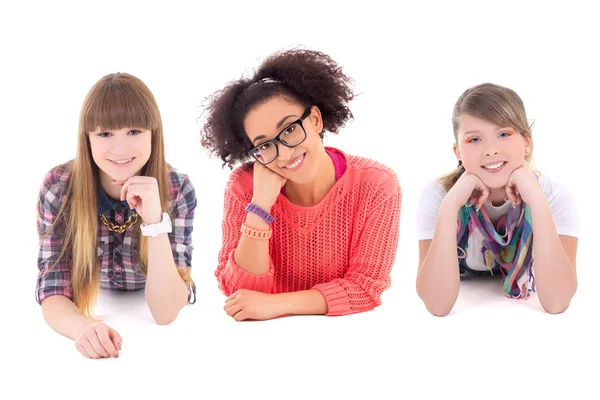 Three happy teenage girls lying isolated on white — Stock Photo, Image