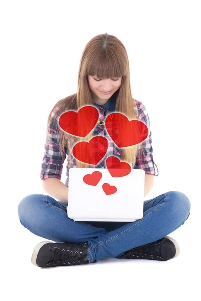 Cute teenage girl sitting and sending love messages with laptop — Stock Photo, Image