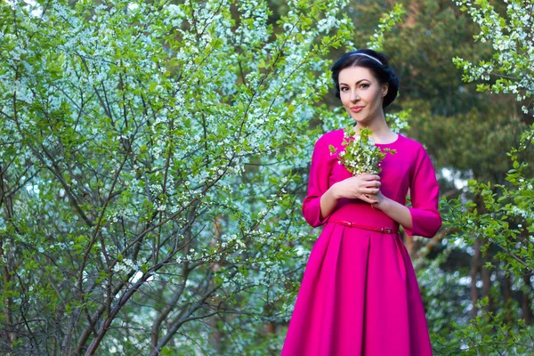 Beautiful dreamy woman walking in spring garden with blooming ch — Stock Fotó