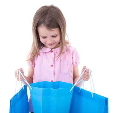 shopping concept - cute little girl with bags isolated on white