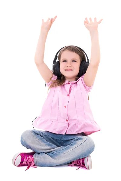 Cute little girl enjoying music in headphones isolated on white — Stockfoto