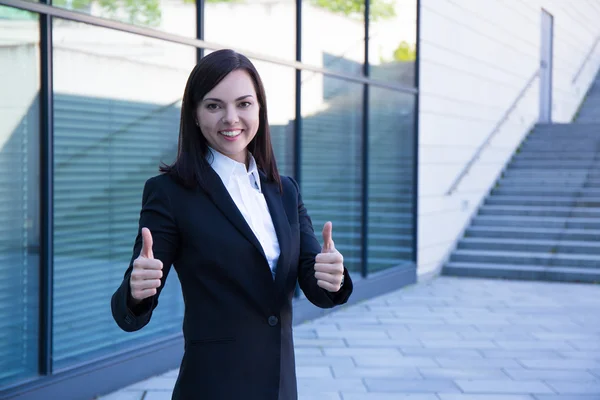 Career concept - business woman thumbs up over modern city backg — ストック写真