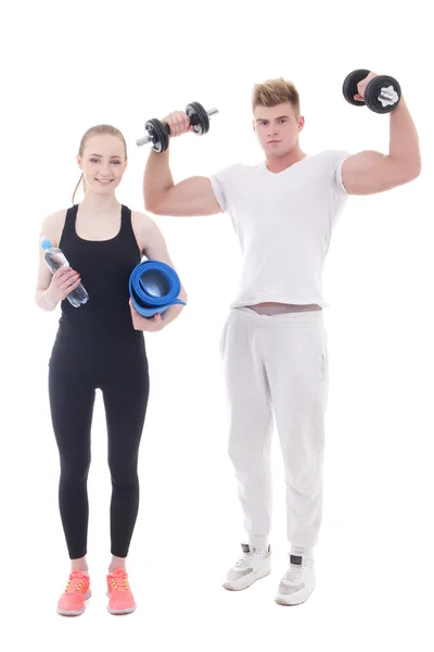 Young man and woman in sportswear with dumbbells and yoga mat is — Zdjęcie stockowe