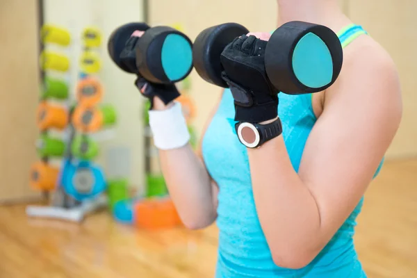 Woman exercising with dumbbell in gym — Stock Photo, Image