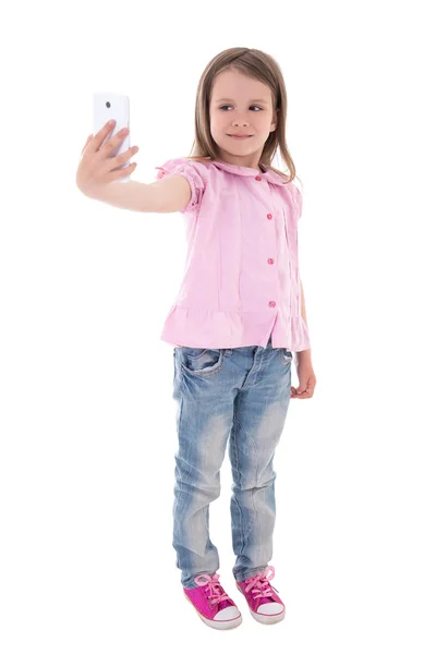 Funny cute little girl taking selfie photo with smart phone isol — Stock Photo, Image