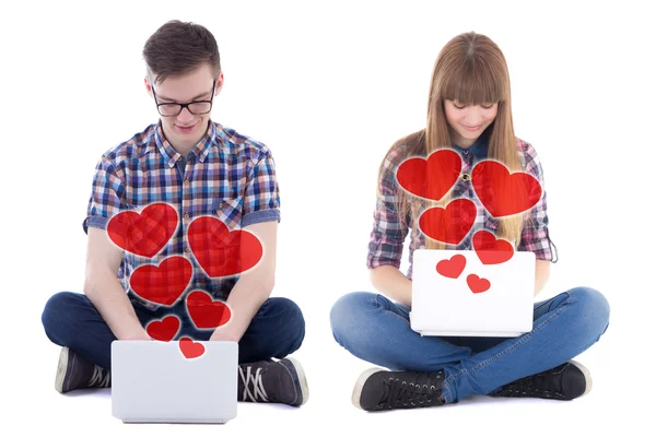 Online dating concept - teenage boy and girl sitting with comput — Stock Photo, Image