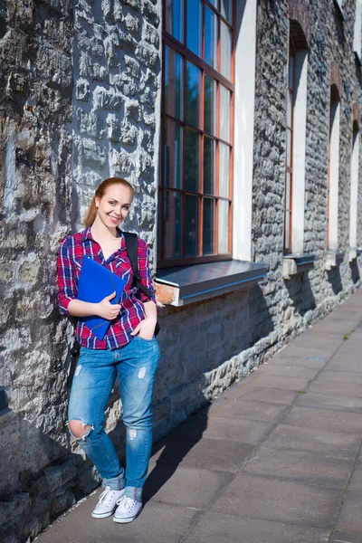 Smiling teenage student girl with backpack standing on street — Stock Photo, Image