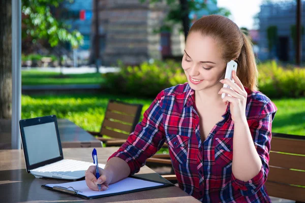 Happy student or school girl talking on mobile phone in park — Stock Photo, Image