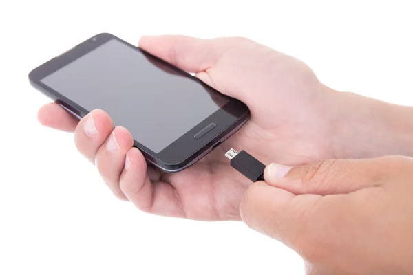 Smart telefon med tom skärm och laddare i hand isolerad på wh — Stockfoto