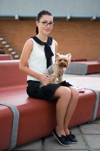 Cute girl sitting with dog yorkshire terrier in park — Stock Photo, Image