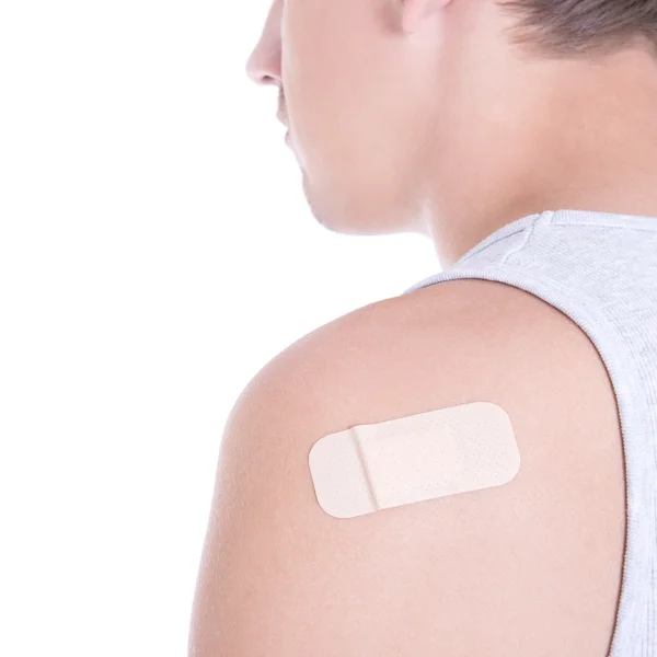 Close up of medical adhesive plaster on male shoulder isolated o — Stock Photo, Image