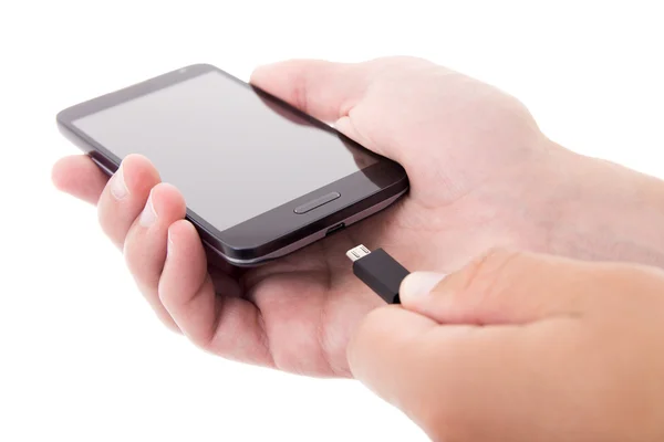 Smart telefon med tom skärm och laddare i manliga händer isolerade — Stockfoto