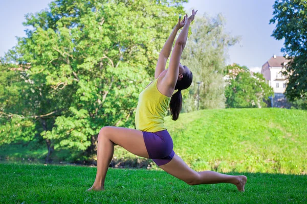 Genç kadının Park - Hilal ay poz yoga egzersizleri yapması — Stok fotoğraf