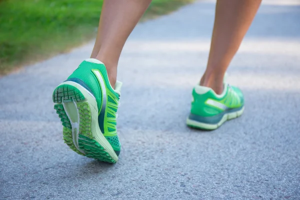 jogging woman in green running shoes