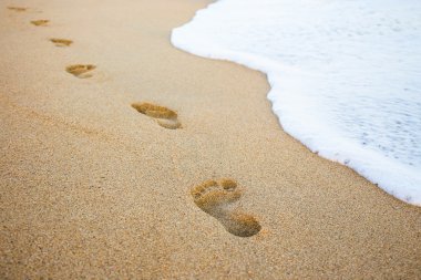 footprints in the sand and sea wave clipart