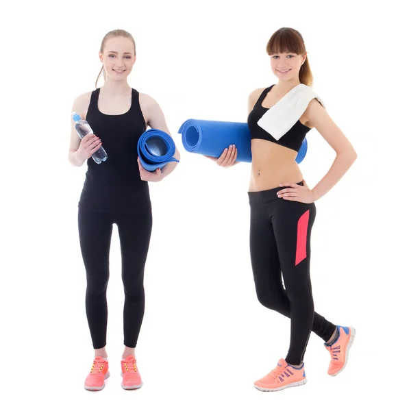 Two beautiful women in sportswear with yoga mats isolated on whi — Stock Photo, Image