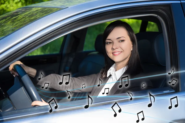 Business woman listening music in car — Stock Photo, Image