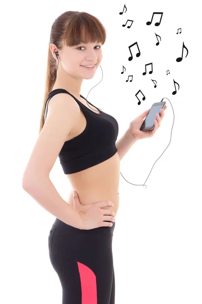Beautiful sporty woman listening music with phone over white — Stock Photo, Image