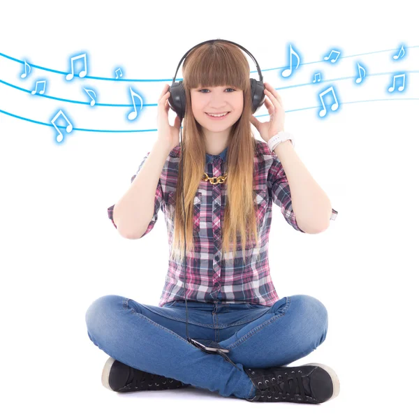 Cute teenage girl sitting and listening music with headphones ov — Stock Photo, Image