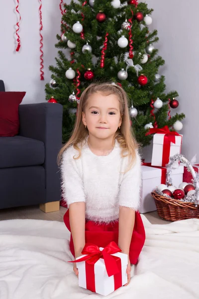 크리스마스 트리 장식된 거실에 앉아 어린 소녀 — 스톡 사진