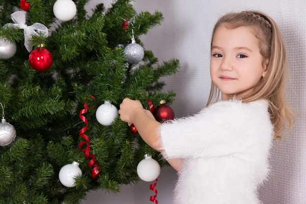 Little girl decorating Christmas tree at home — Stock Photo, Image