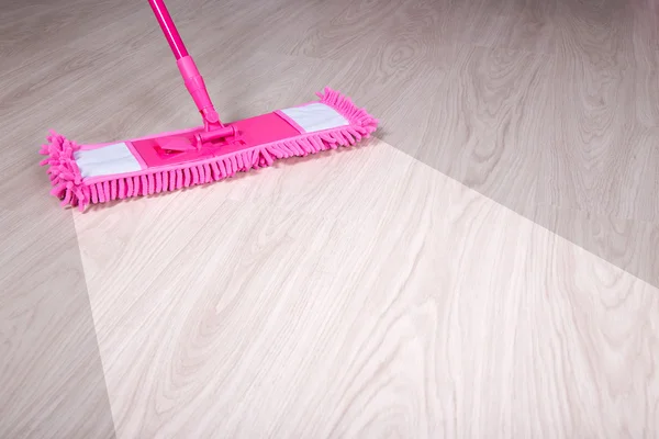 Cleaning, before and after concept - wooden floor with pink mop — Stock Photo, Image