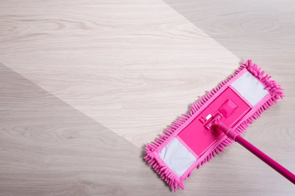 Before and after cleaning - close up of pink floor mop on wooden — Stock Photo, Image