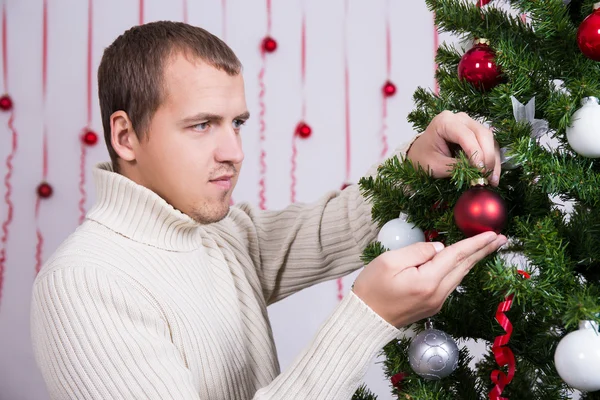 Christmas concept - portrait of handsome man decorating Christma — Stock Photo, Image