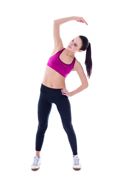 Slim donna in abbigliamento sportivo facendo esercizi di stretching isolati su — Foto Stock