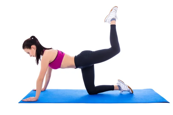 Beautiful slim woman doing stretching exercises on yoga mat isol — Stock Photo, Image
