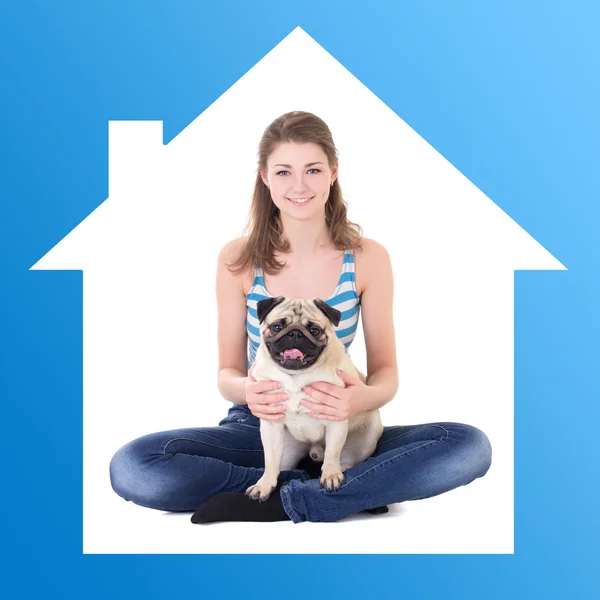 Home concept - beautiful woman holding pug dog in blue house fra — ストック写真