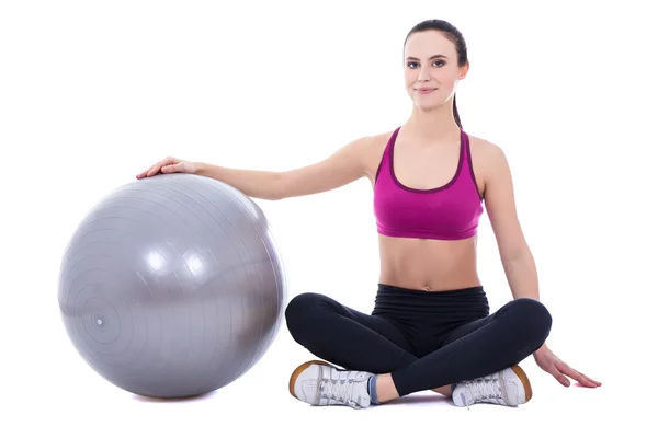 Young woman in sports wear sitting with fitness ball isolated on — Φωτογραφία Αρχείου