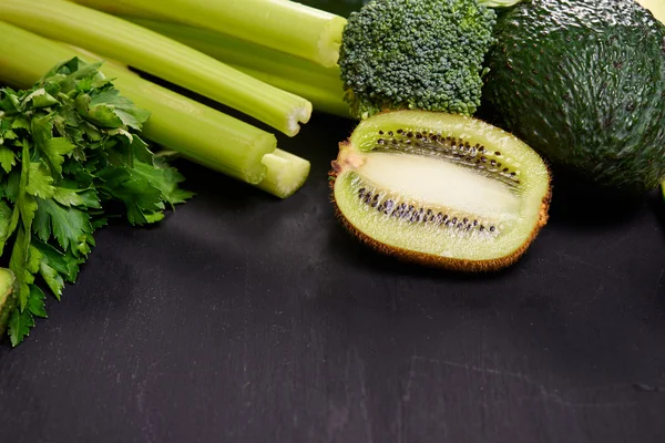 Green vegetables over dark background — Stock Photo, Image