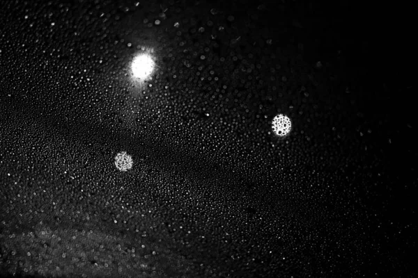 Glass with rain drops against dark background. — Stock Photo, Image